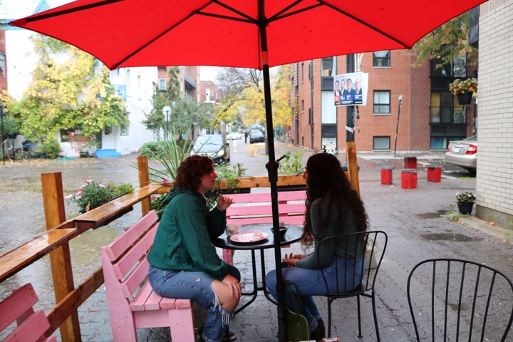 Two girls at a coffee shop while it rains